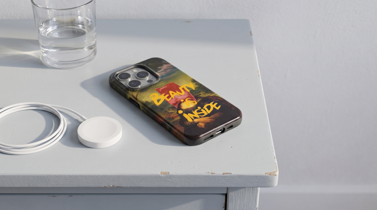 Mona Lisa iPhone tough case on a bedside table beside a magnetic charging puck in early morning light