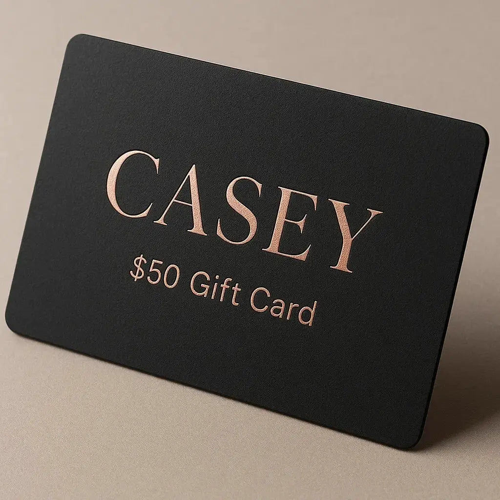 Black gift card with 'CASEY' and '$50 Gift Card' text on a beige background